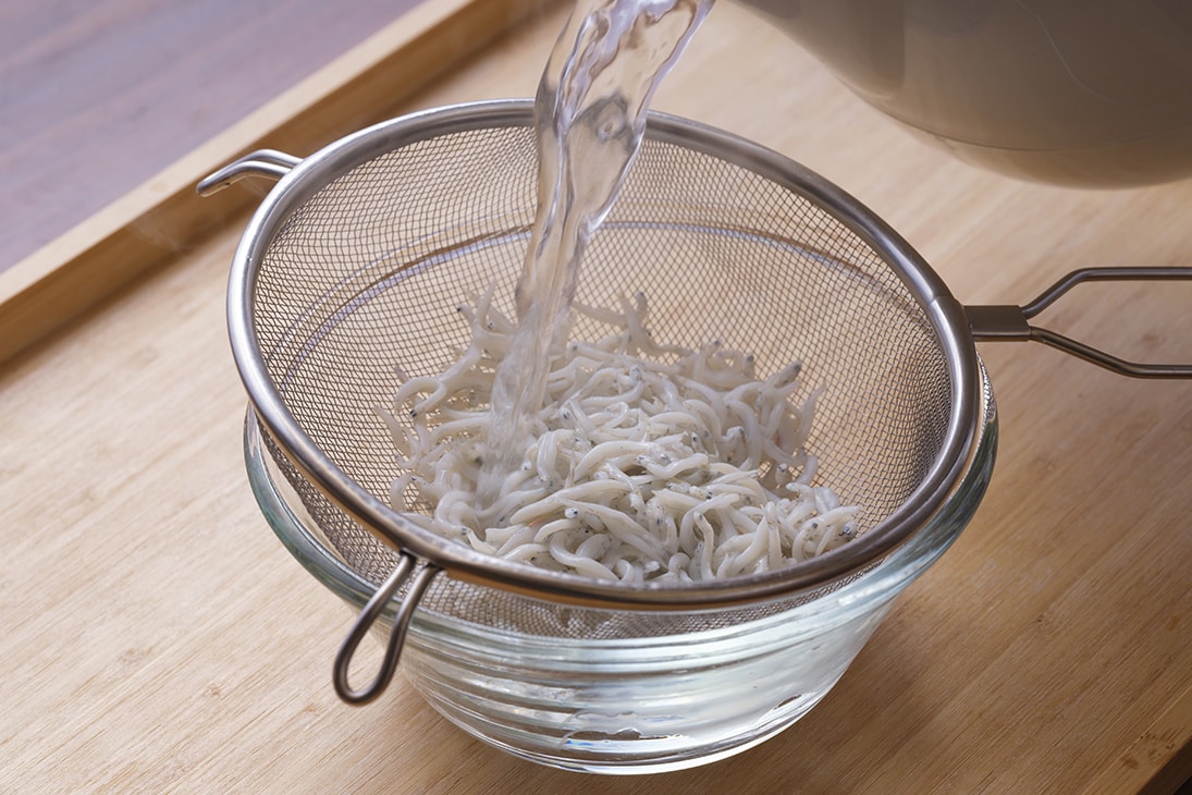 しらすをザルに入れて熱湯を回しかけ、湯をきる。